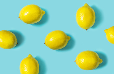 Top view of fresh lemon isolated on blue background. Fruit minimal concept.