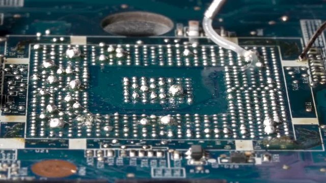 Apply flux and solder balls for a successful reball procedure on the pcb. Closeup macro.
