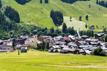 Parish Church of Saint Nicholas and Bartholomew in Saalbach, Austria, sunny summer day