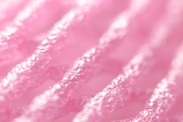 Macro closeup surface of soft pink fruit net with light shine on