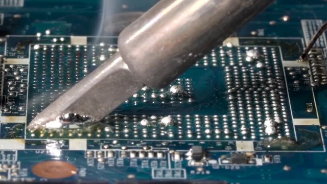 Removing bga balls from the pcb. bga rework station. Closeup macro.