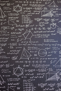 Math on black board with many solution - vertical