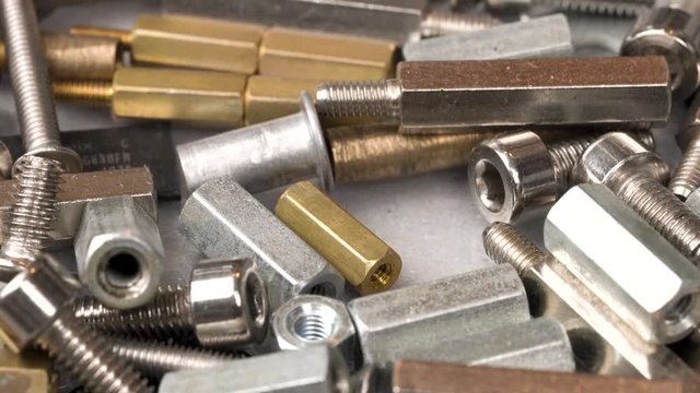 Closeup macro of choosing the right pcb stand spacer size using the tweezers. Closeup macro.