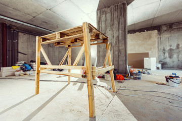 Composition with paint and decorator's tools near wall