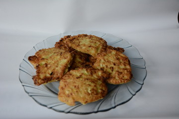 fried zucchini fritters on a wooden tablechopsticks from the fragrant green courgettes of the homemade cuisine