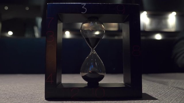 Hourglass in dark.time, inexorable, past
