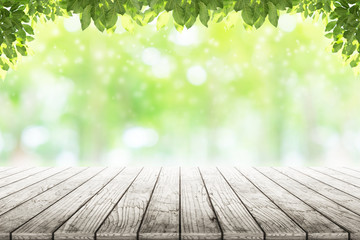 Empty wooden table  with beautiful garden background blurred.