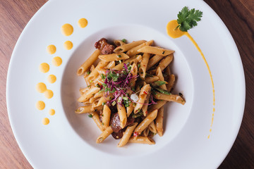 Top view of Penne with crispy fish and sweeten pork in Thai spicy chili sauce (Nam phrik long ruea).