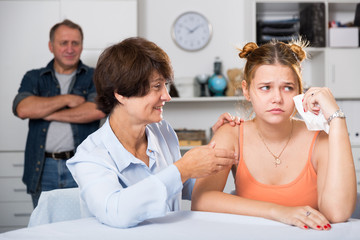 Adult woman is carefully talking with a sad daughter