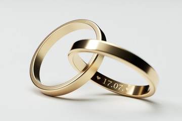 Isolated golden wedding rings with date 17. July