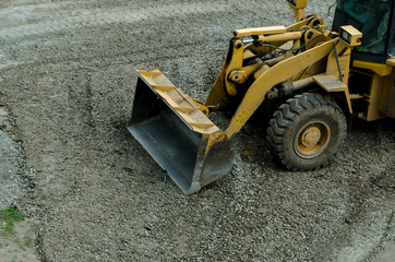 the tractor is leveling the road from the stones