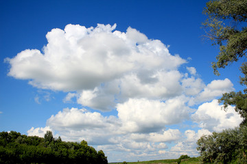blue sky and heavy, white clouds