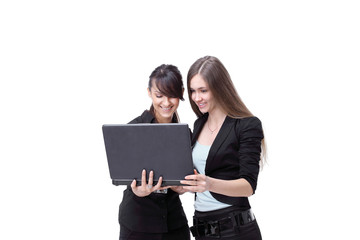 two girls discuss work on a laptop