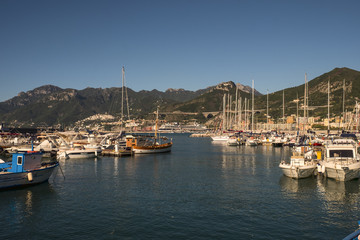 View of the busy harbor at sunrise with ships and containers on the dock. Amalfi Coast. Region...