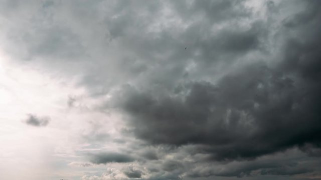 Time lapse 4K of dramatic storm fluffy clouds at blue sky background