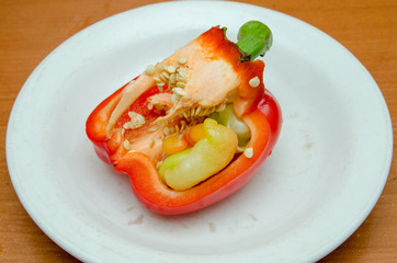 red pepper lies on a plate, pepper with seeds