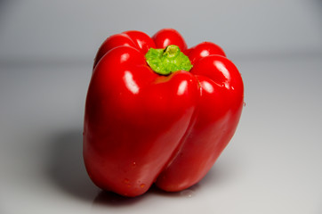 red pepper lies on a plate, pepper with seeds