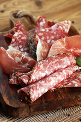 Food tray with delicious salami, raw ham and italian crudo or jamon. Meat platter with selection