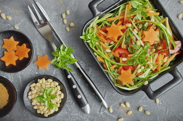 Spaghetti from zucchini. Raw food diet: uncooked spaghetti zucchini with paprika, carrots, pine nuts and fresh Basil