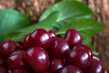 Red cherry by close-up, on wood background