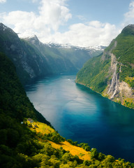 Fototapeta na wymiar Breathtaking view of Sunnylvsfjorden fjord and famous Seven Sisters waterfalls, near Geiranger village in western Norway.