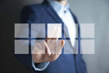 Businessman pressing virtual buttons in concept