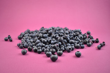 Blueberries stock images. Blueberries on a purple background. Healthy summer fruit