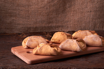 Cookies with cottage cheese - sochnik on wooden desk. Classic colors. Warm photo