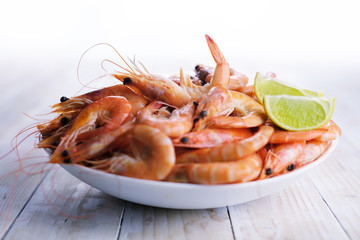 Big boiled shrimps in white plate close up. Seafood concept. Food photography