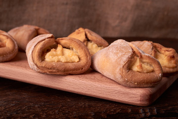 fresh pies with cottage cheese from a yeast dough on a wooden desk, baking with cottage cheese. Concept of small business bakery