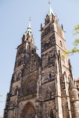 Fototapeta premium Saint Lawrence cathedral on the blue sky background. Medieval gothic church in Nuremberg, Bavaria, Germany