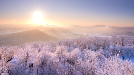 Beautiful winter sunrise lanscape with hills