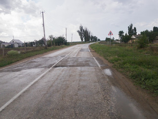 Road in countryside after rain / Winding road in countryside after rain on cloudy day