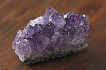 Amethyst stone. Natural Amethyst stones of minerals on a background of natural wood American black...