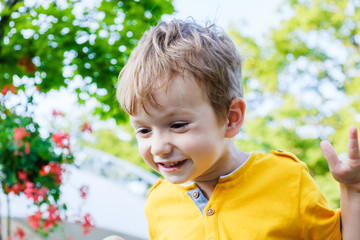 Happy caucasian boy smiling enjoying life. Portrait of young boy in nature, park or outdoors....