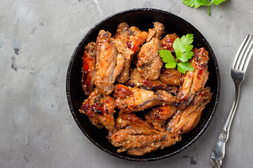 Grilled chicken teriyaki on gray stone background. Top view.
