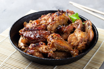 Grilled chicken teriyaki on gray stone background.