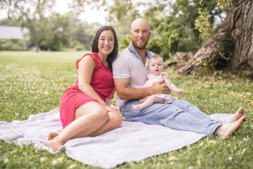 Fototapeta premium Happy family with Baby girl lay on a blanket