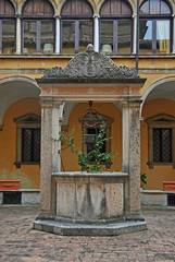 Italy, Bologna well in the Santissimo Salvatore basilica complex cloister.