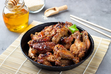 Grilled chicken teriyaki on gray stone background.