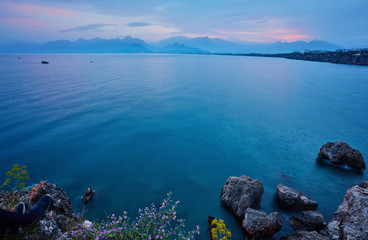 Seascape timelapse of high mountains over clear sunset sky in Antalya, Turkey.