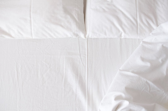 White bedding sheets and pillows