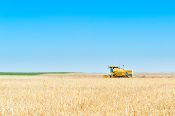 Harvester performing mowing tasks in the field.