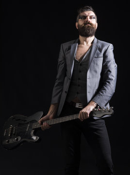 Music party and entertainment. Bearded man with guitar ready to play at music party. Man go to music party. Guitarist with musical instrument at music party. Ear knowledge for your soul
