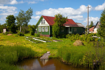Old wooden house in rural vegetable garden