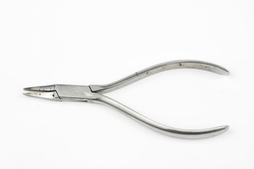 Pliers and cable cutters on a white table. Accessories for DIY enthusiasts and electricians.