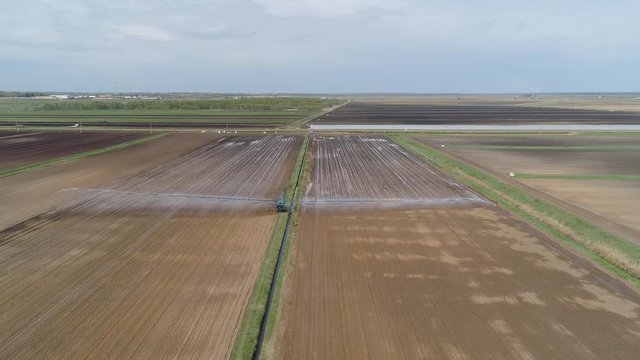 Aerial view of Crop Irrigation using the center pivot sprinkler system. An irrigation pivot watering agricultural land. Irrigation system watering farm land.