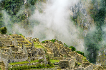 Inca residences area of Machu Picchu with cliff in the background