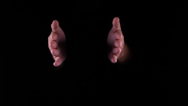 Hand Gestures coming out of the dark into the light. Holding GFX object. hand spread out vertical and horizontal.
