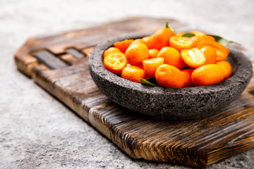 Kumquat on the gray background. Bright Citrus.